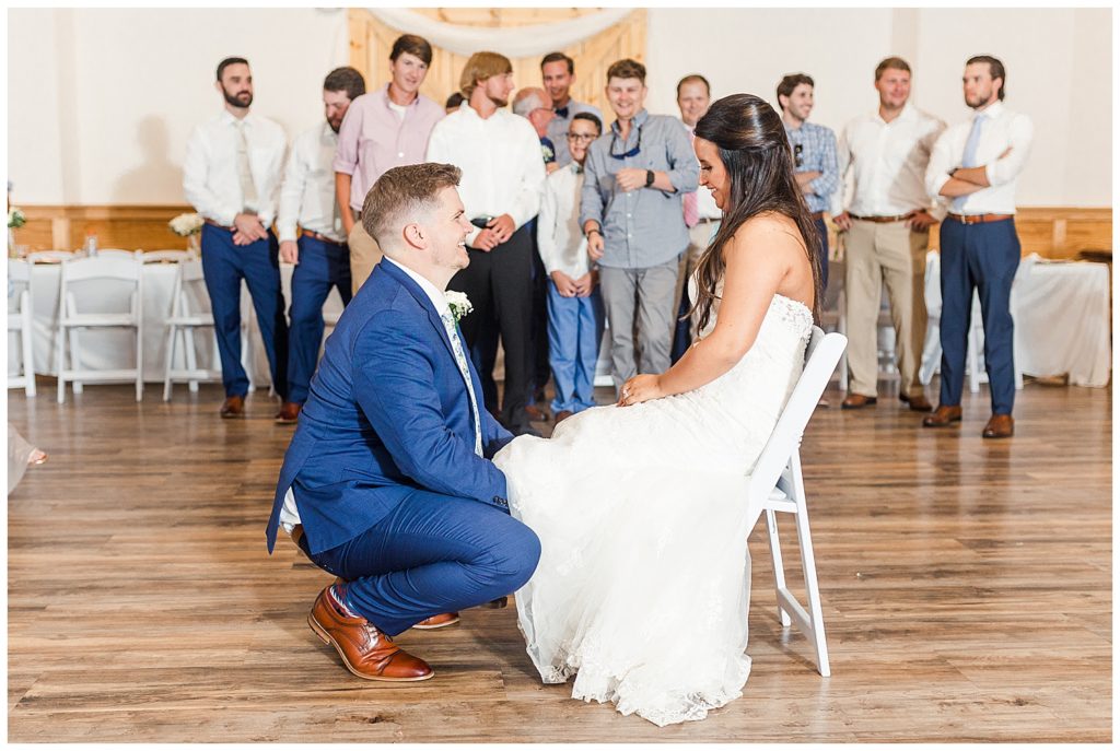 garter toss wedding day bride and groom reception photography